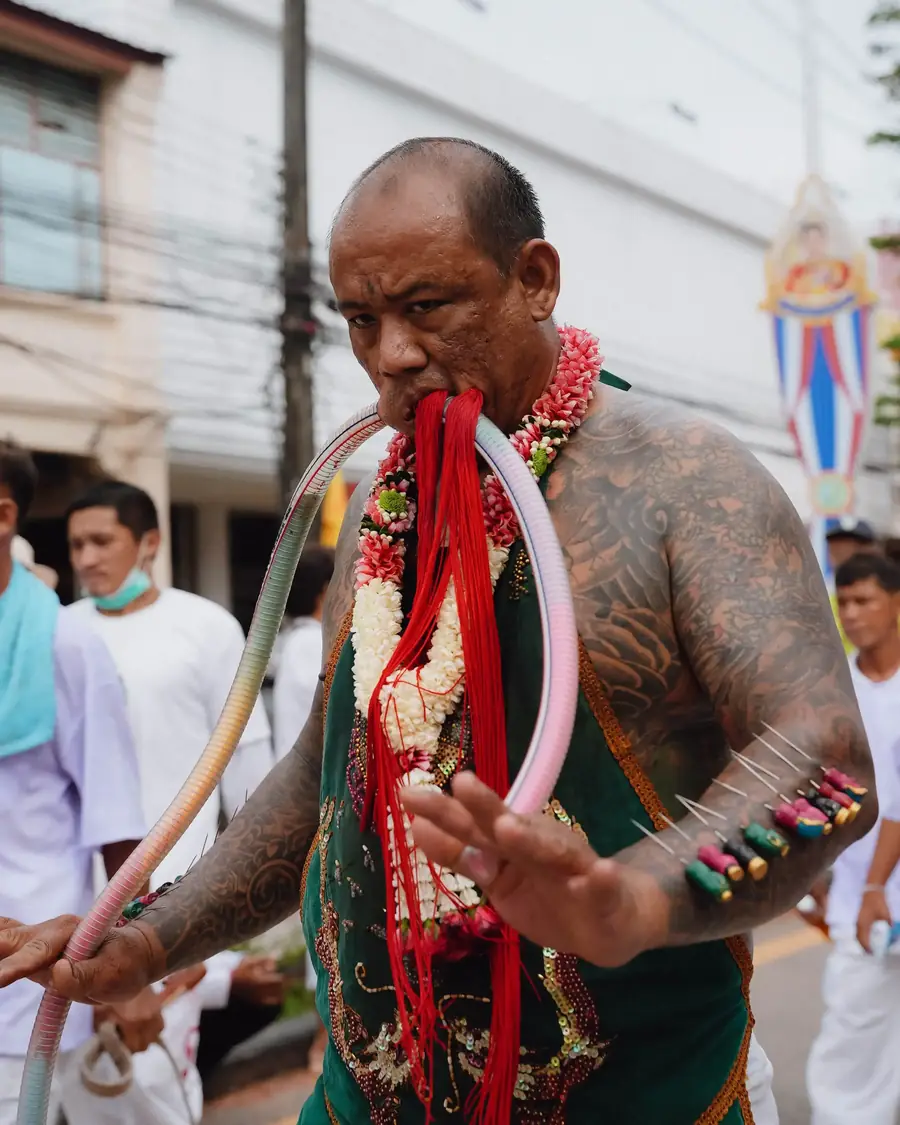 Dancers in golden crowns and silk costumes carrying lotus-shaped offerings